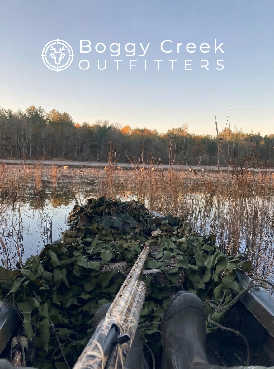 Hunter overlooking a marsh at sunset at Boggy Creek Outfitters